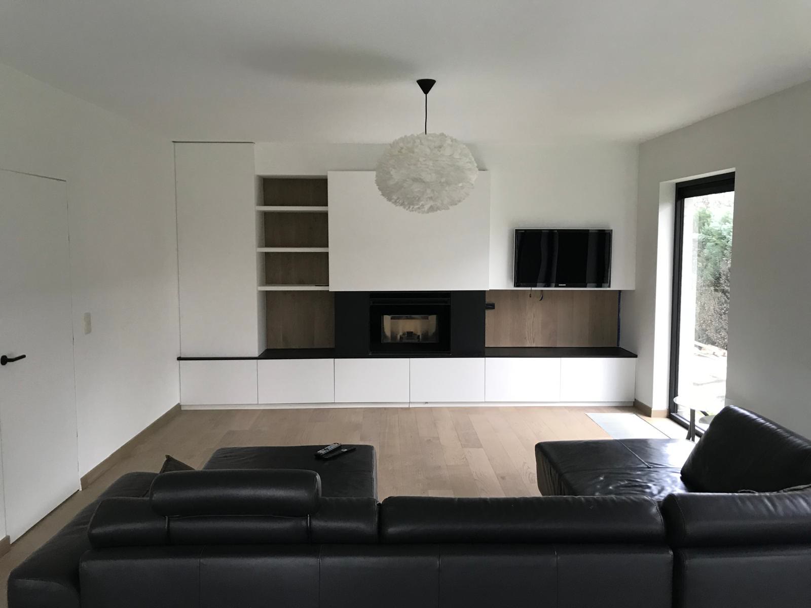 White living room with fitted units and a fireplace